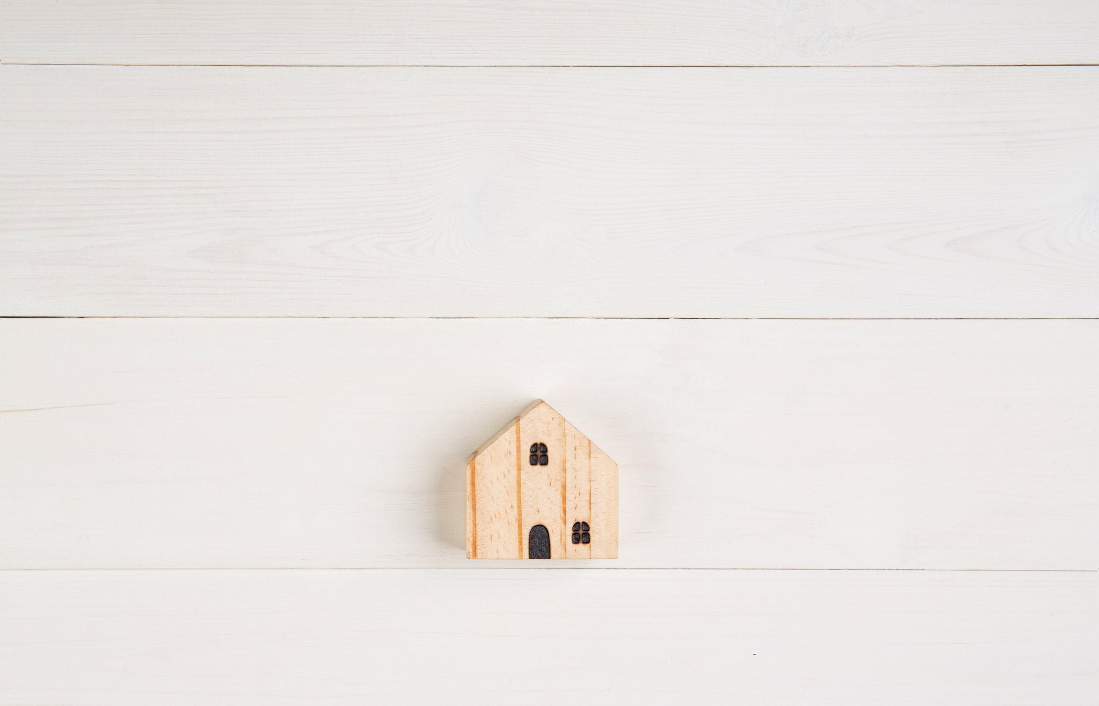 Wooden House Model on White Background Copy Space